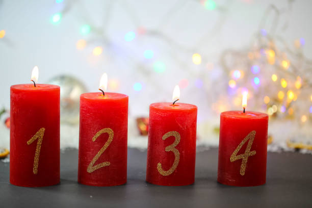 istock burning candles on red background, christmas background 1183071052