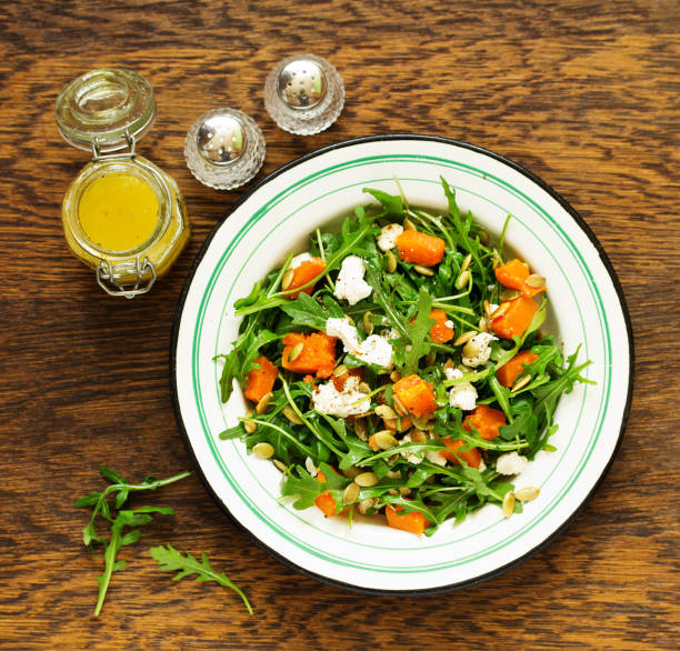 salad with pumpkin, feta and arugula. . Selective focus