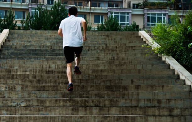 istock Man running up outdoor stairs 1183074975