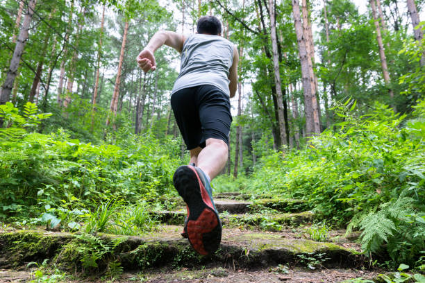 istock Man running on the steps of forest 1183075135