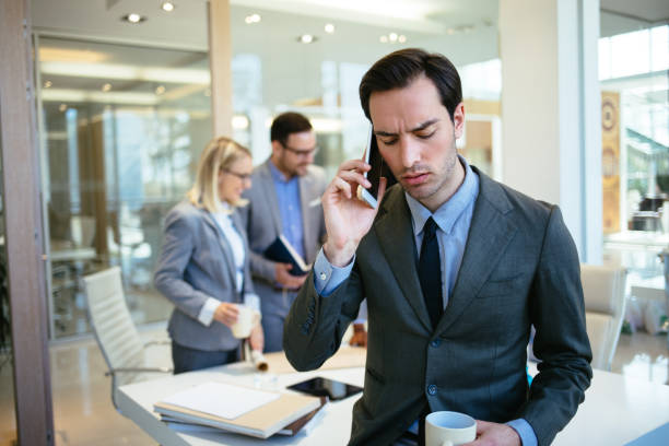 istock Businessman talking on mobile phone in the office 1183075153