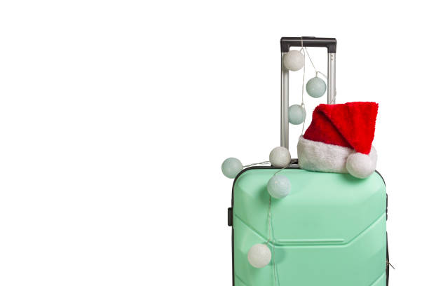 istock Plastic suitcase, Santa Claus cap and garland on a white backgro 1183076021