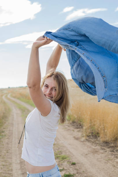 istock Beautiful young woman in a field 1183077192