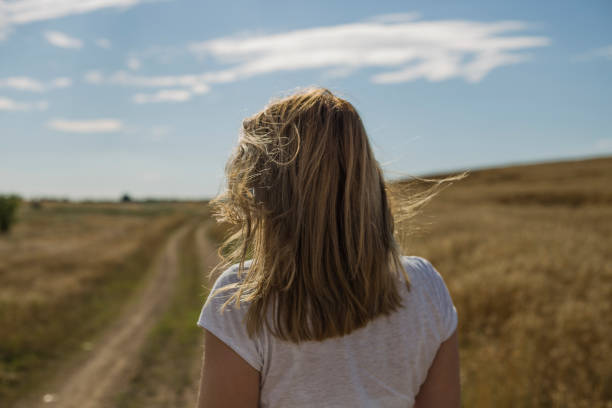 istock Beautiful young woman in a field 1183077205