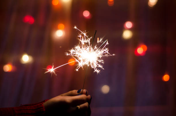 istock Person hold a sparkler stick in a hand 1183077893