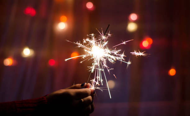 istock Person hold a sparkler stick in a hand 1183077902