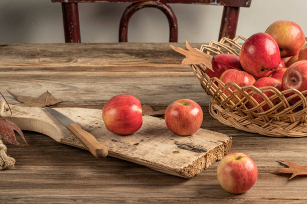 istock ripe red apples on a wooden cutting boad on table 1183079238