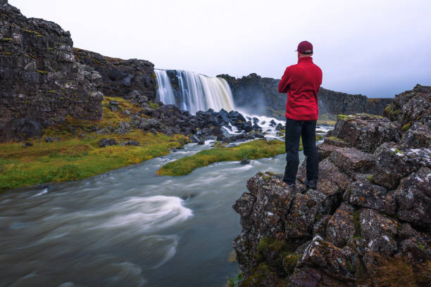 istock Tourist looking at the Oxarafoss waterfall in Iceland 1183082967