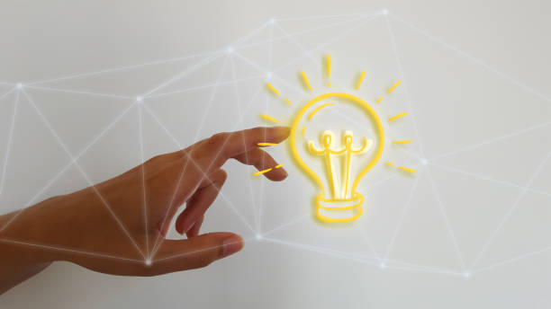 istock Woman hand on blurred background touching digital light bulb 1183083038