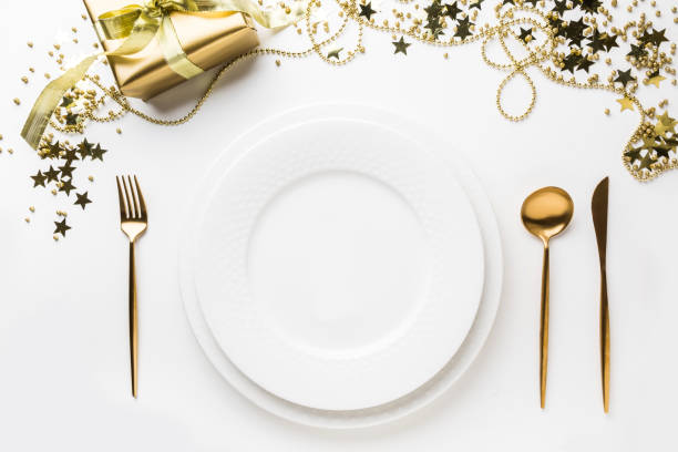 istock Christmas table setting with golden cutlery and decor on white background. Top view. 1183085543