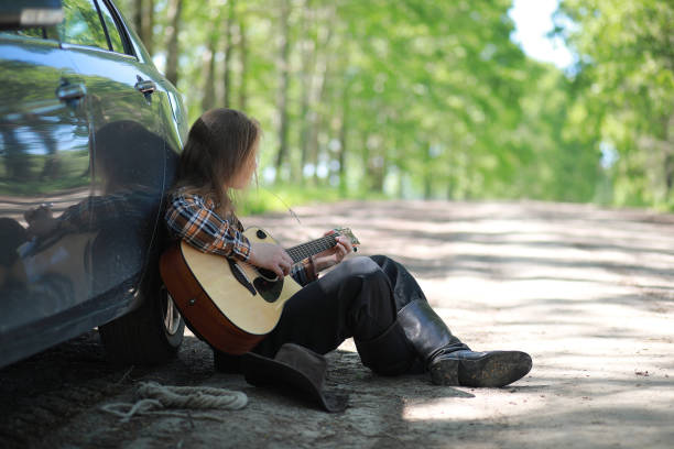 istock A man with a guitar on summer day outdoors 1183085619