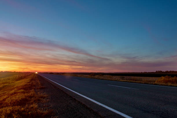 istock car headlights on highway at night 1183087545