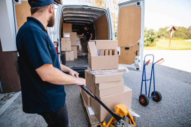istock Team of Expert Gig Delivery Drivers Loading Van with Parcels 1183087618