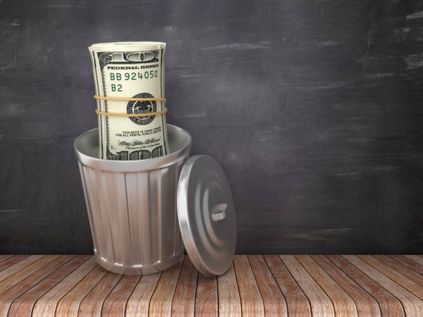istock Trash Can with Dollar Money Roll on Chalkboard Background - 3D Rendering 1183087846