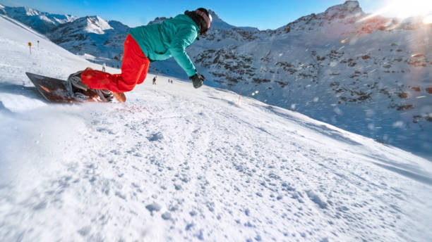 istock Woman snowboarding on mountain 1183087929