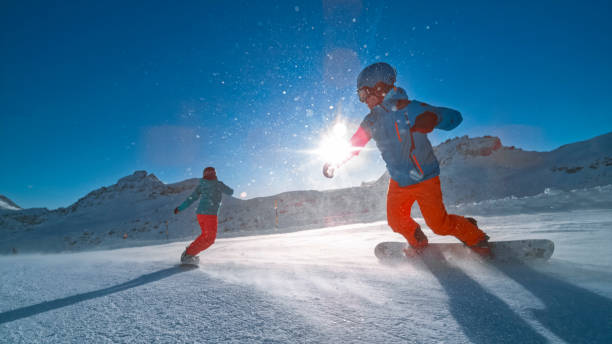 istock Man and woman snowboarding on mountain 1183087932