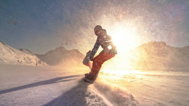 istock Man and woman snowboarding on mountain 1183087940