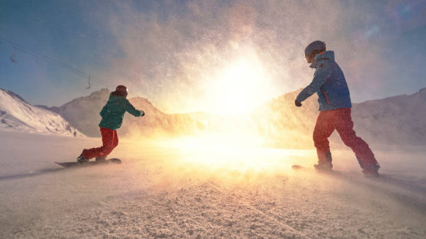 istock Man and woman snowboarding on mountain 1183087946