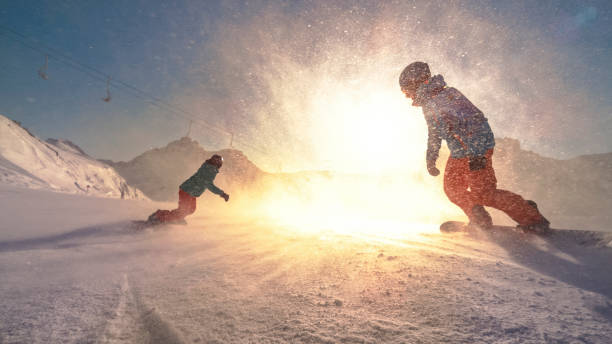 istock Man and woman snowboarding on mountain 1183088333
