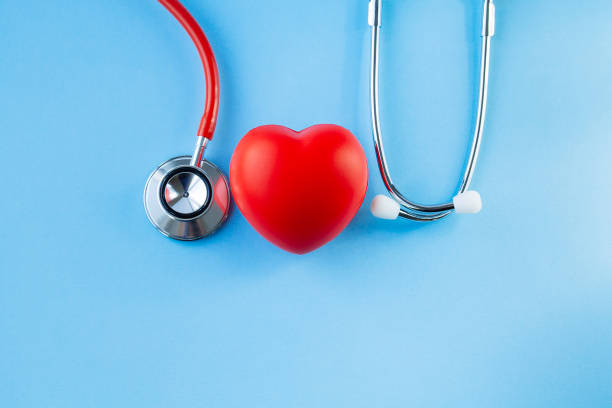 istock Stethoscope and red heart on blue background. 1183089249