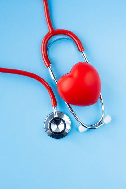 istock Stethoscope and red heart on blue background. 1183089280