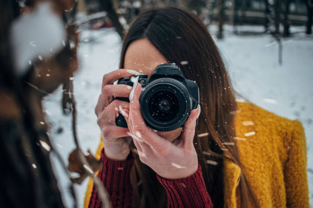 istock Young woman with camera 1183089379