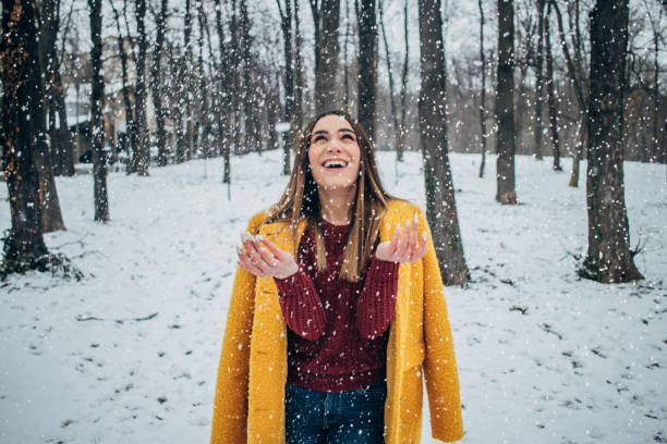 istock Pretty woman having fun with snow 1183089835