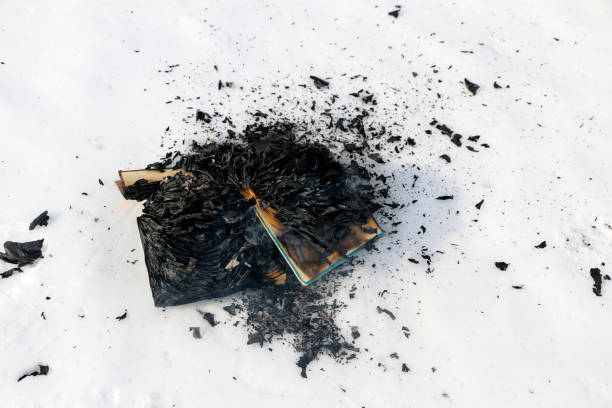burning book in the snow. pages with the text in the open book burn with a bright flame.