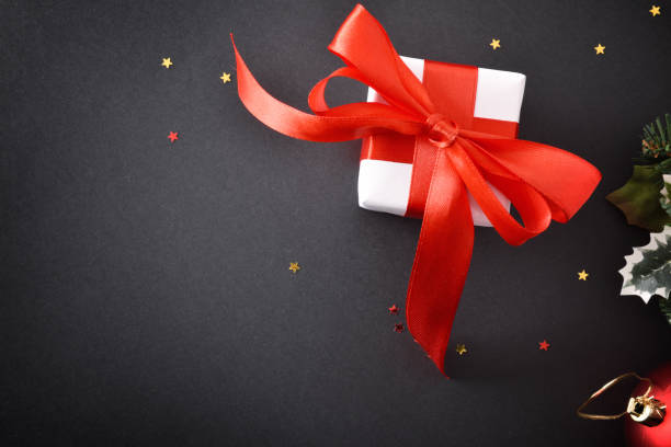 istock White christmas gift boxes on black table with ornaments top 1183091119