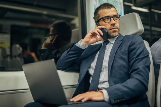 istock Handsome gentleman using laptop in subway train 1183093284