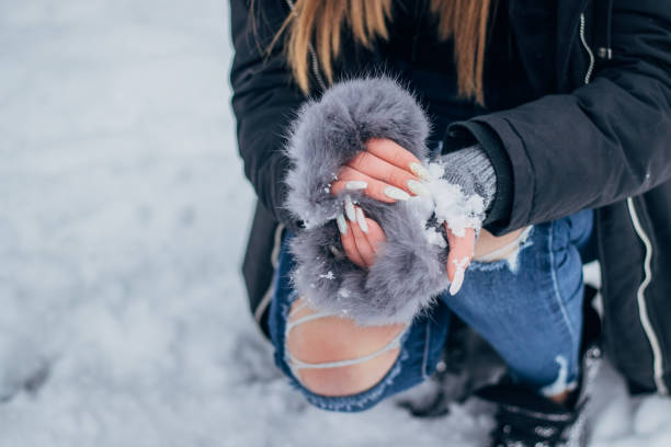 istock Young woman making snowballs 1183094254