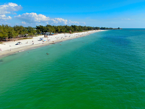 Aerial view of Coquina Beach white sand beach and turquoise water in Bradenton Beach during blue summer day, Anna Maria Island, Florida. USA