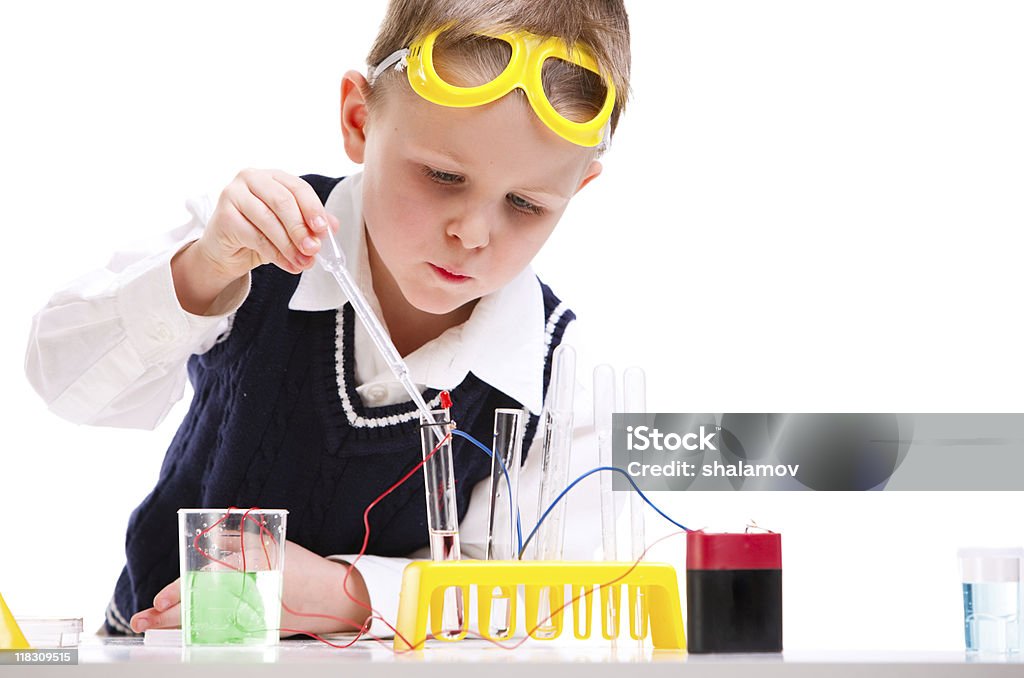 A little boy playing with a science kit Young boy performing chemistry experiments with different liquids. Boys Stock Photo