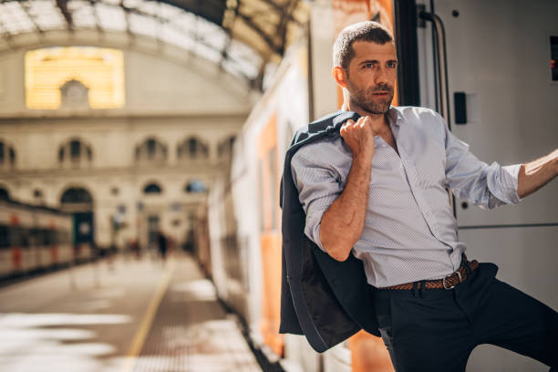 istock Handsome businessman going traveling by train 1183095595