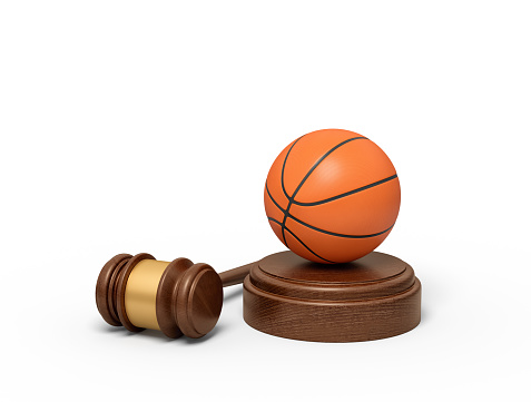 3d rendering of basketball on sounding block with judge gavel lying beside. Fair basketball game. Law for sport. Abide by rules.