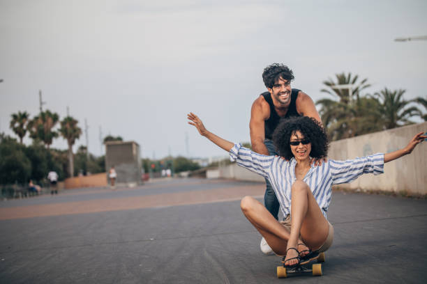 istock Couple having fun with skateboard together 1183099892