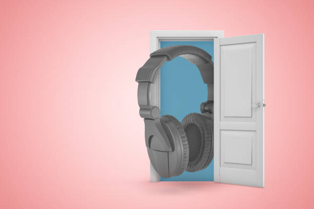 istock 3d rendering of huge black headset emerging from white door on pink gradient copy space background. 1183100575