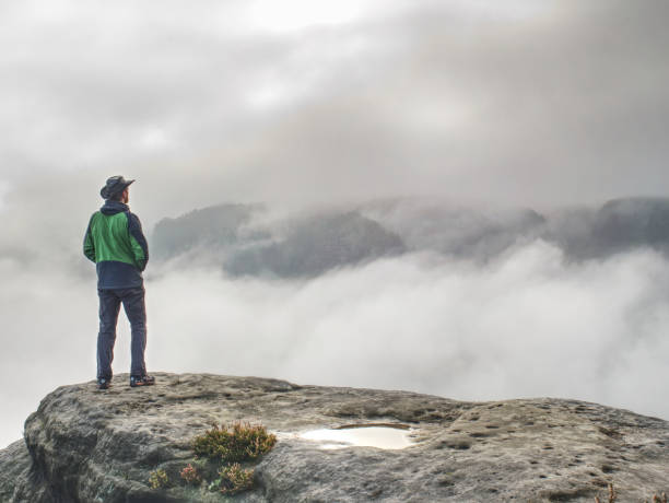 istock tall hiker on sharp cliff of sandstone rock in rock park 1183101361