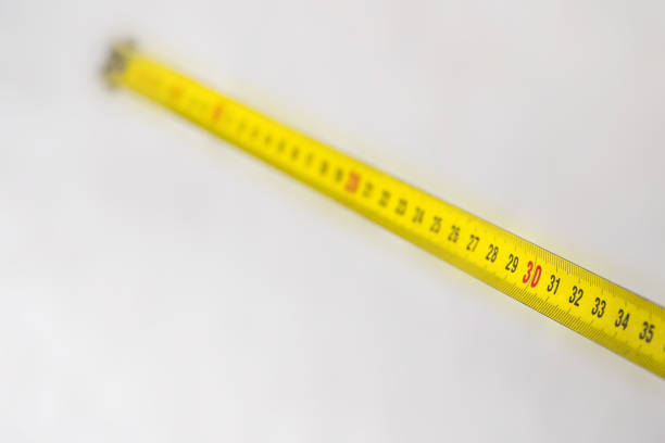 istock Yellow measuring tape with size 30 on white 1183101522