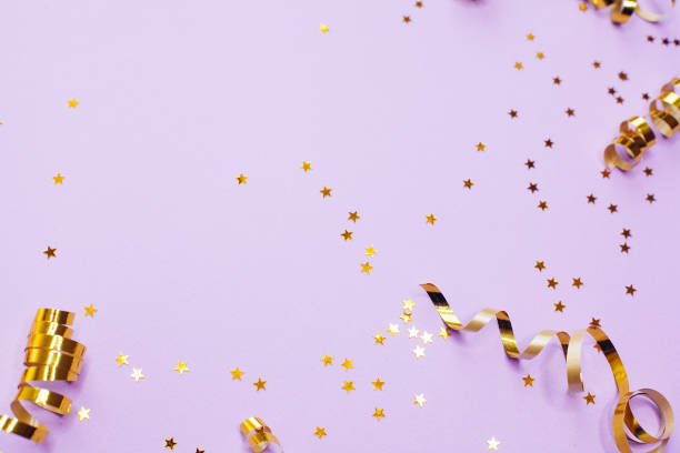 istock Golden decorations and sparkles on pale purple background 1183101944