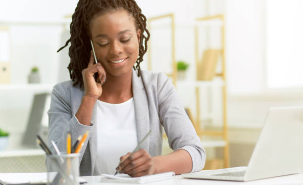 istock Office Girl Having Phone Conversation With Clients Sitting At Workplace 1183102118