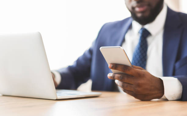 istock Close up of businessman using cellphone at workplace 1183102265