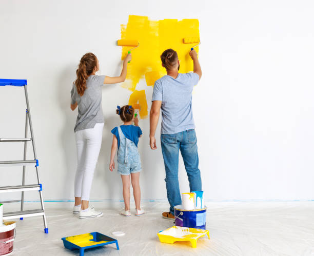 Repair in apartment. Happy family mother, father and child daughter  paints wall Repair in the apartment. Happy family mother, father  and child daughter    paints the wall with   paint house painter ladder paint men stock pictures, royalty-free photos & images