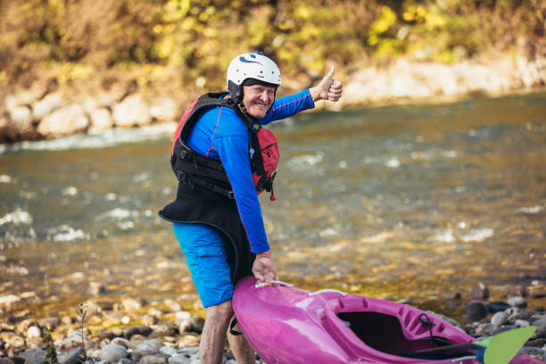 istock Senior man preparing for kayak tour on a mountain river. 1183103265