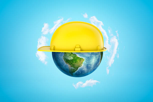 istock 3d rendering of earth sphere with yellow hard hat on blue background 1183103308