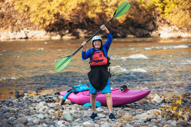 istock Senior man preparing for kayak tour on a mountain river. 1183103322