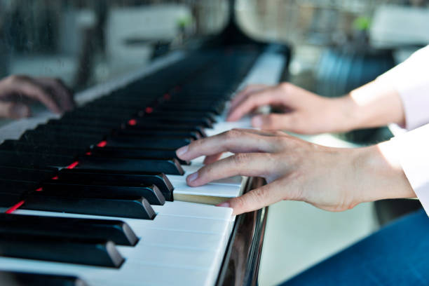 istock Woman hands playing piano 1183103383