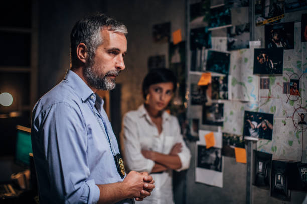 istock Two FBI agents looking for clues in office 1183103979