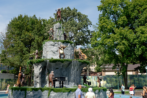 Kharkiv, Ukraine, August 2019 Monkey music band. Apes play and sing. Creative fun sculpture of animal musician. Outside park decoration among rocks, grass, trees and sky