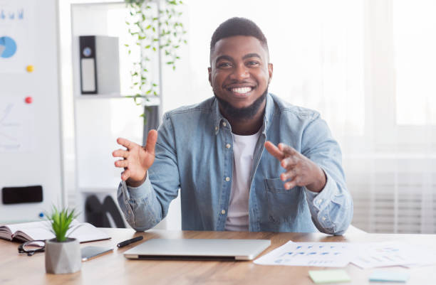 istock Smiling business coach sharing his experience and creative ideas at camera 1183104757